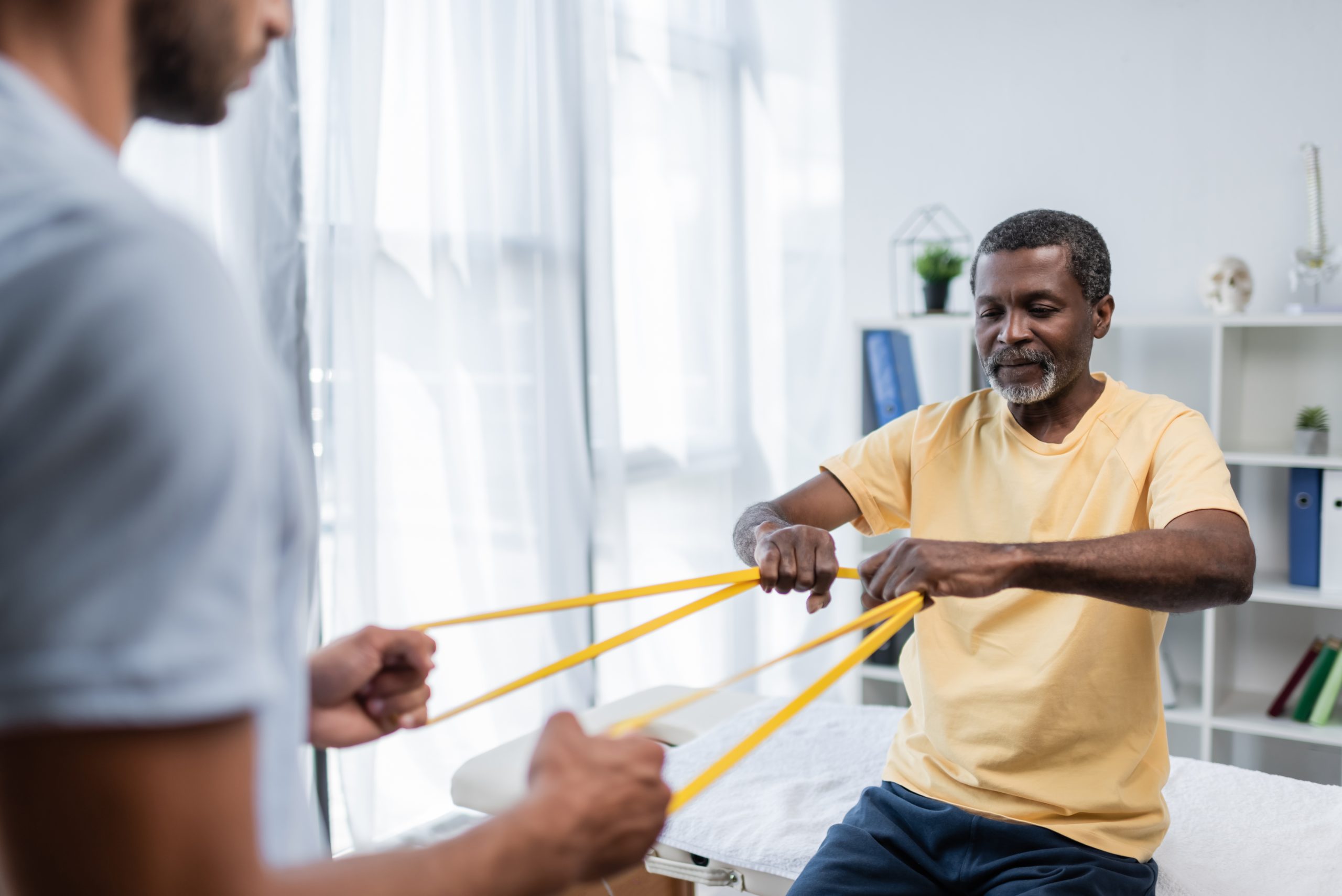 Physical Therapy Assistant Helping Patient